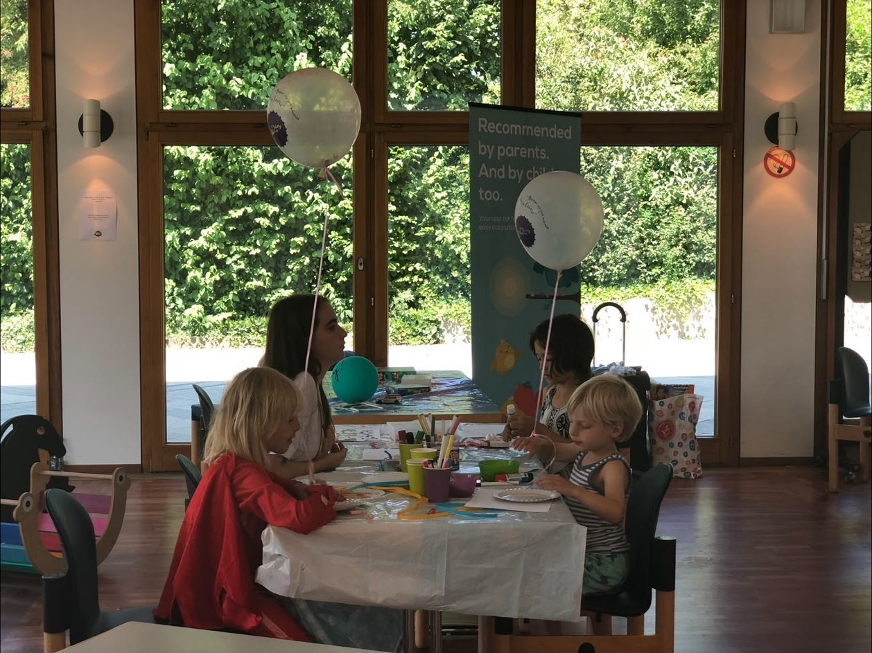 Children painting and crafting together at the Mamalicious market