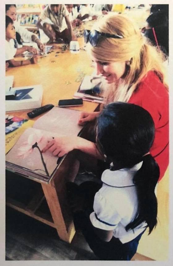 A volunteer drawing with a child at the Mahrberg Library in Cambodia